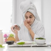 front-view-woman-applying-face-cream
